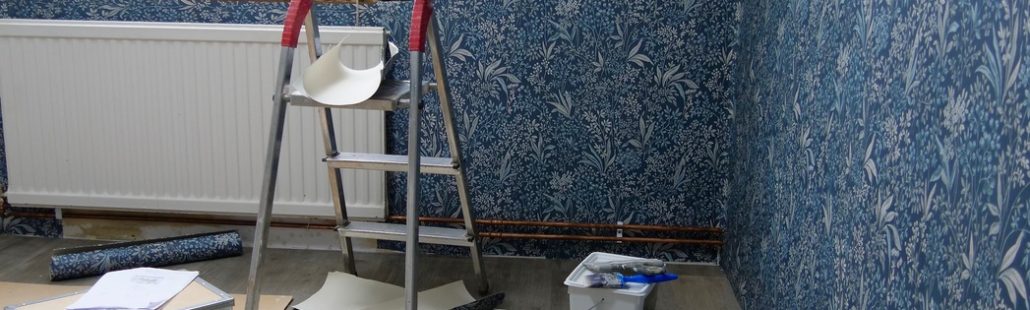 Wallpaper being applied to a wall, showcasing the smooth installation process and professional craftsmanship.