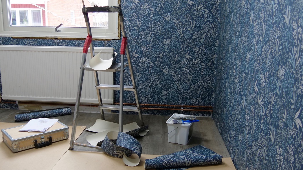 Wallpaper being applied to a wall, showcasing the smooth installation process and professional craftsmanship.